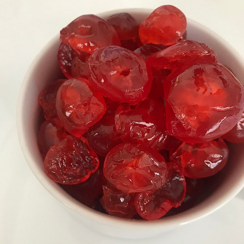 A bowl of red broken and whole glazed cherries 